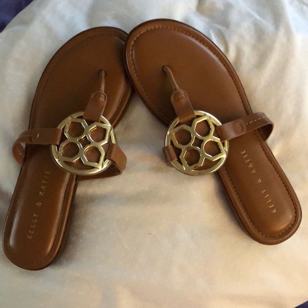 Brown sandal with gold emblem